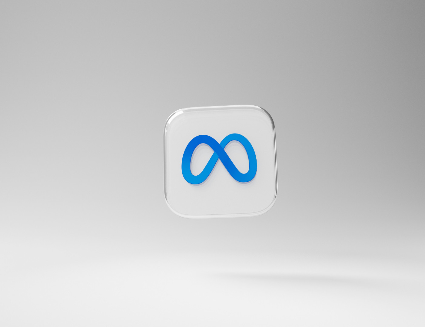 Ein transparentes, quadratisches 3D-Element (Rendering) mit abgerundeten Ecken zeigt das blaue Meta-Logo in der Mitte vor einem hellgrauen Hintergrund. Ein Chitchat über Meta Muse, Meta AI, Vibes und Meta One von SR-STUDIOS. | SR-STUDIOS