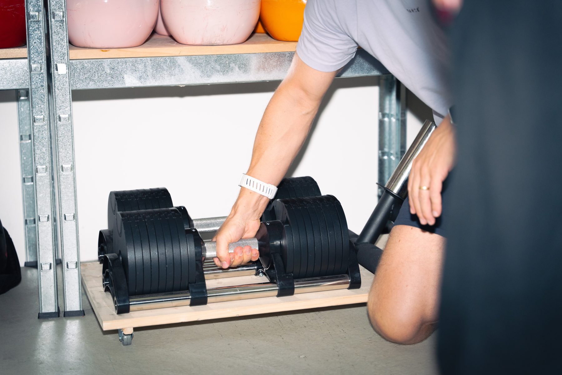 Eine männliche Hand greift nach einer Kurzhantel im Fitnessraum von OnMind Basel während des Content-Workshops von SR-STUDIOS. | SR-STUDIOS