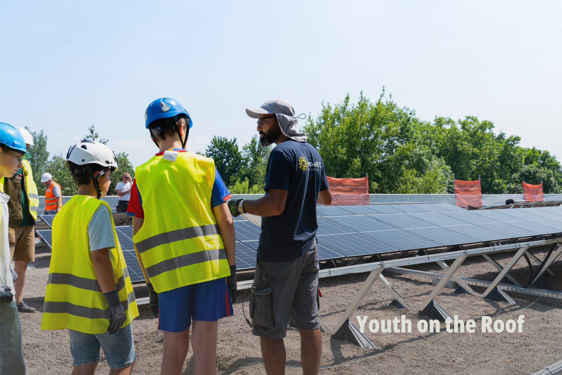 Action-Shot vor Ort: Youth on the Roof - Kinder in Warnwesten besprechen die Installation einer Freiflächen-Solaranlage; Planeco GmbH. | SR-STUDIOS